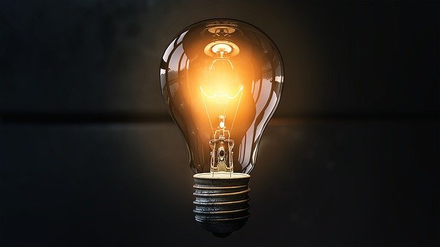 lit up lightbulb with a black background